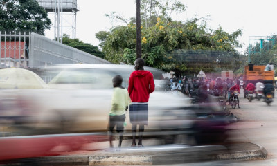 Two children crossing a busy main road in Africa reflecting climate change