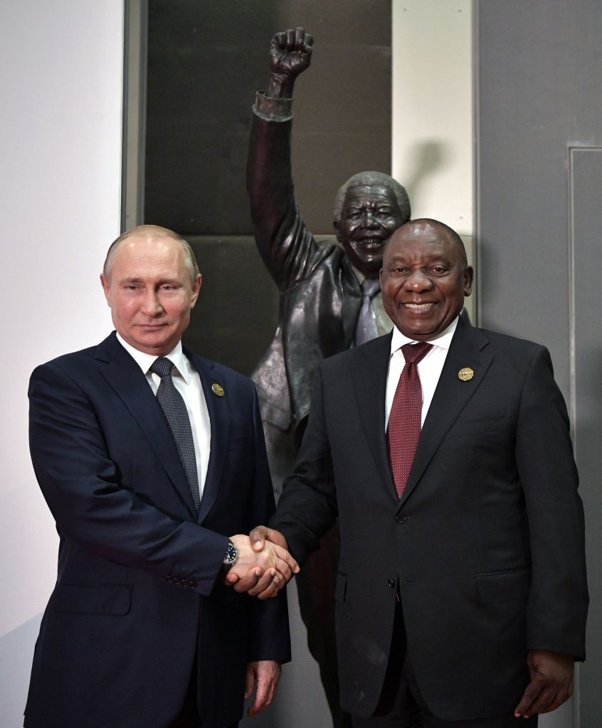 Russia's President Vladimir Putin (L) shakes hands with South Africa's President Cyril Ramaphosa before posing for a group picture during the 10th BRICS (acronym for the grouping of the world's leading emerging economies, namely Brazil, Russia, India, China and South Africa) summit on July 26, 2018 at the Sandton Convention Centre in Johannesburg, South Africa. (Photo by Alexey NIKOLSKY / SPUTNIK / AFP)