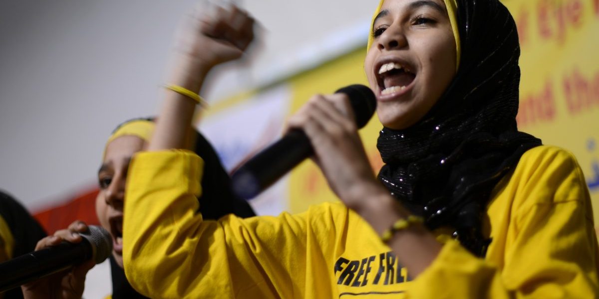 Image: A young Egyptian reads a poem during the protest meeting against the military coup in Egypt to support
Egypt’s first freely elected president, Mohamed Morsi, who was removed from power by the military on
November 17, 2013 in New Jersey, United States (Cem Ozdel /Anadolu Agency/Getty)