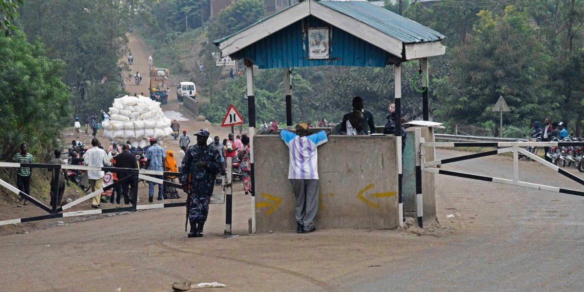 A Ugandan police officer stands guard at the Mpondwe check point at the border with the DRC. Image: Getty, Isaac Kasamani/AFP