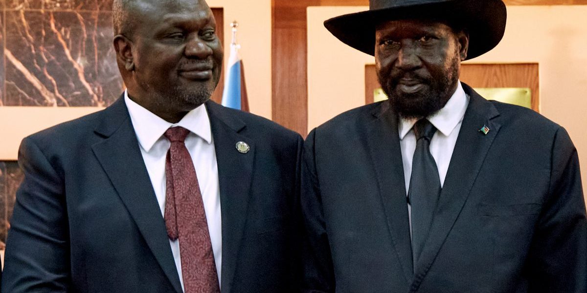 South Sudanese President Salva Kiir (R) shakes hands with First Vice President Riek Machar as he attends his swearing-in ceremony at State House in Juba, South Sudan on February 22, 2020. Image: Getty, Alex Mcbride/AFP