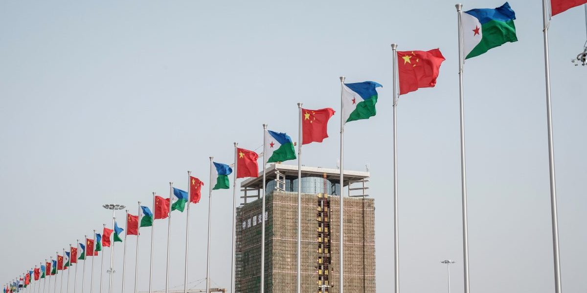 National flags of China (red) and Djibouti are seen in front ot Djibouti International Free Trade Zone (DIFTZ) before the inauguration ceremony in Djibouti on July 5, 2018. Image: Getty, Yasuyoshi Chiba/AFP