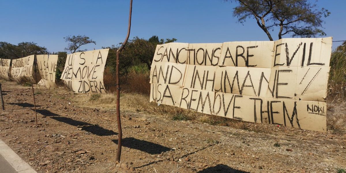 Aditi pic Protest signs from demonstrators camped outside the US Embassy in Harare calling for the lifting of sanctions on Zimbabwe, on 1 August 2019. Image: Aditi Lalbahadur
