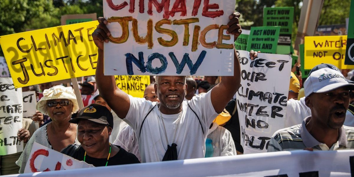 Protesters sing while holding up placards that read "Fridays for Future" during a rally in Johannesburg for climate action on September 20, 2019, as part of a Global Climate Action day. Image: Getty, Michele Spatari/AFP
