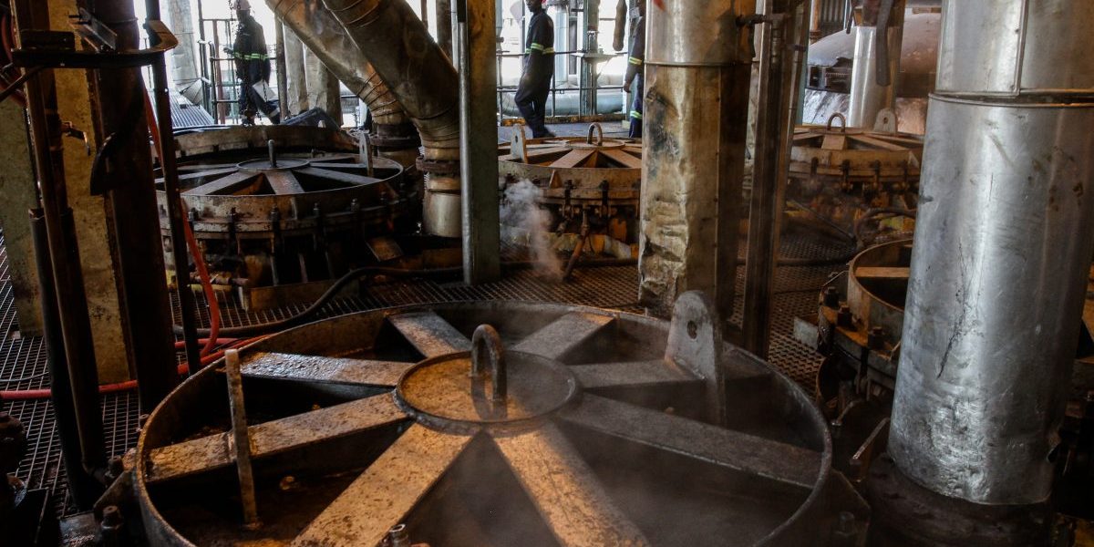 Workers perform maintenance on machinery used for processing sugarcane at the Sezela Mill, operated by Illovo Sugar, in Sezela, South Africa. Image: Getty, Dean Hutton/Bloomberg