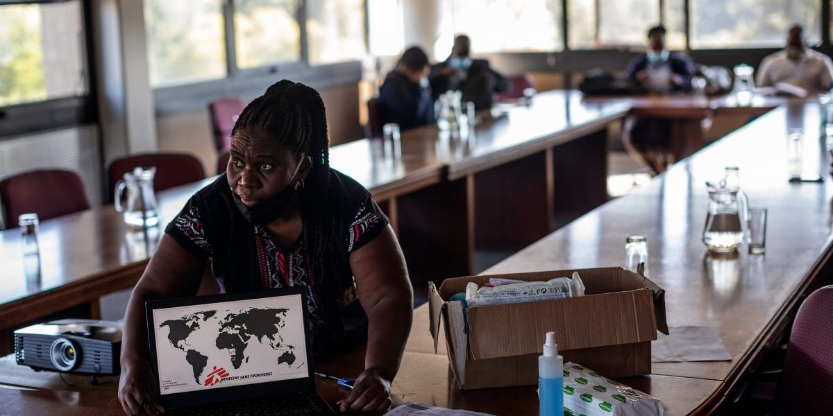 Doctors Without Borders (MSF) nurse Bhelekazi Mdlalose, sets up her computer to be used during a COVID-19 coronavirus training course for nurses at the City of Joburg Civic Centre in Roodeport, Johannesburg, on May 13, 2020. Image: Getty, Michele Spatari/AFP
