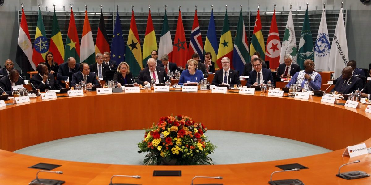 German Chancellor Angela Merkel (R) speaks with the President of Ghana, Nana Ando Dankwa AkufoAddo, in the G20 conference Compact with Africa in Berlin, Germany. Image: Getty, Felipe Trueba-Pool