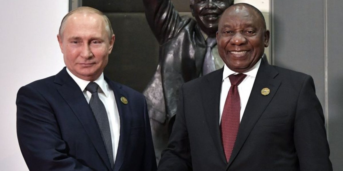 Russia's President Vladimir Putin (L) shakes hands with South Africa's President Cyril Ramaphosa before posing for a group picture during the 10th BRICS (acronym for the grouping of the world's leading emerging economies, namely Brazil, Russia, India, China and South Africa) summit on July 26, 2018 at the Sandton Convention Centre in Johannesburg, South Africa. (Photo by Alexey NIKOLSKY / SPUTNIK / AFP)