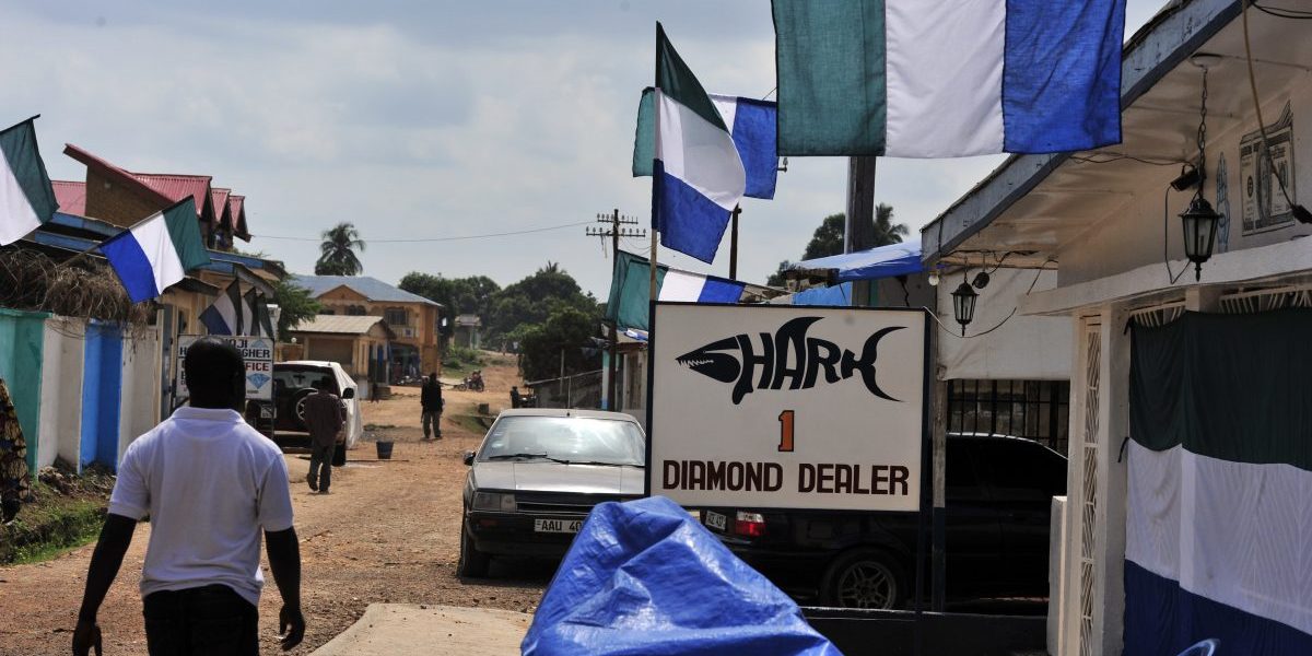 A resident walks by a diamond dealer's shop in Koidu, the capital of the diamond-rich Kono district, in eastern Sierra Leone, April 2012. Image: Getty Issouf Sanogo/AFP