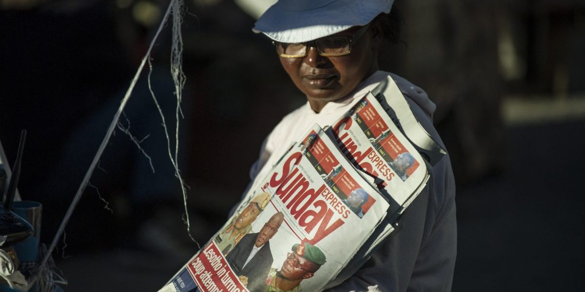 A newspaper seller is pictured on August 31, 2014 in Maseru. Lesotho Prime Minister Tom Thabane claimed on August 30 he fled for his life after soldiers seized power in a coup, despite the military denying it overthrew the tiny mountain kingdom's government. Image: Getty, Mujahid Safodien/AFP