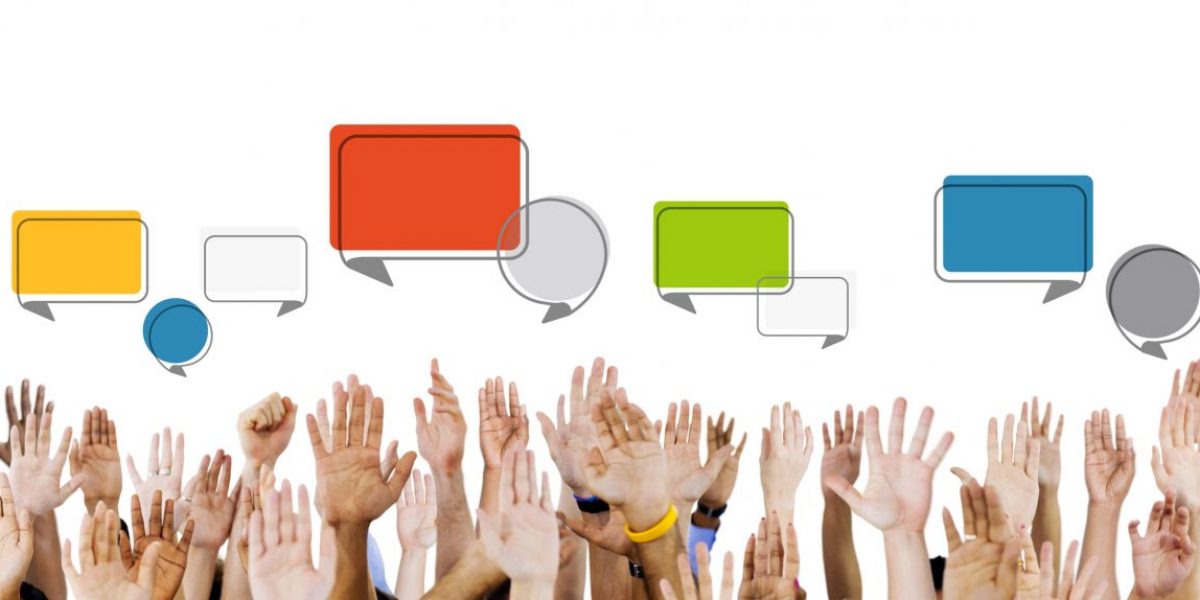 GettyImages-493710163. Multiethnic Hands Raised with Speech Bubbles_Getty, Rawpixeljpg Seeing the Forest – and the Trees: The Global Challenge of Regulating Social Media for Democracy