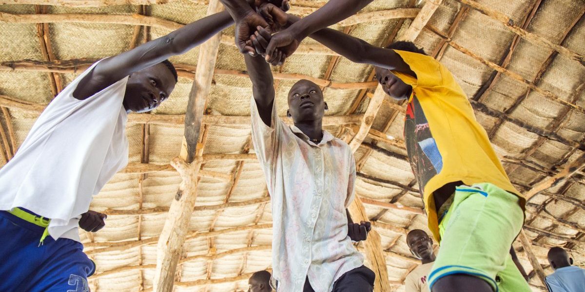 Young refugees from Sudan practice an activity on "trauma healing" at a refugee camp, in South Sudan, in May 2017. Image: Getty, ALBERT GONZALEZ FARRAN/AFP