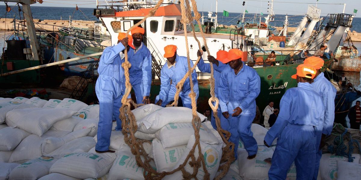 GettyImages-83813405 Workers load a ship_Photo by Mahmud Turkia_AFP Industrialisation in Africa: How Can the G20 Assist?