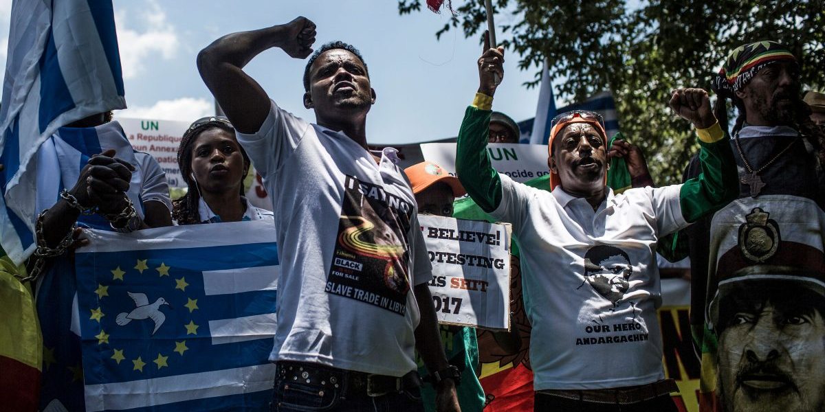 Members of the Africa Diaspora Forum (ADF), civil society organisations, churches, trade unions and other coalitions shout slogans during a demonstration against the slave trade and human trafficking in Libya at the Union Buildings in Pretoria. Image: Gulshan Khan/AFP