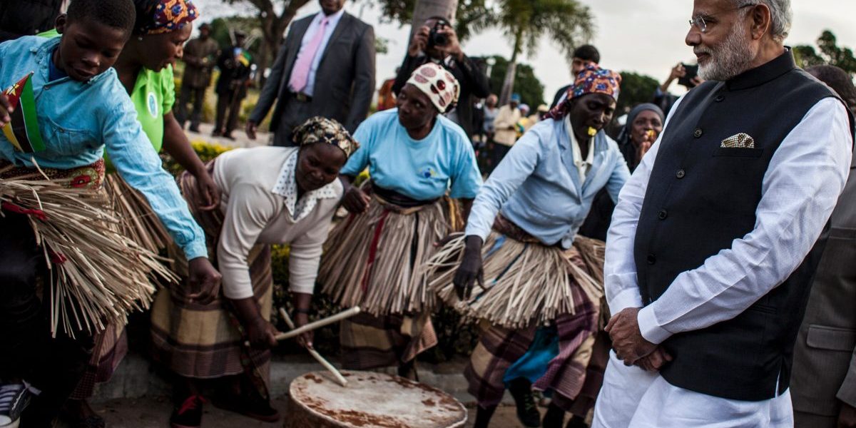 Indian Prime Minister Narendra Modi looks at a band playing, as he arrives for a visit to the Centre for Innovation and Technological Development in Maputo. Image: Getty, John Wessels/AFP