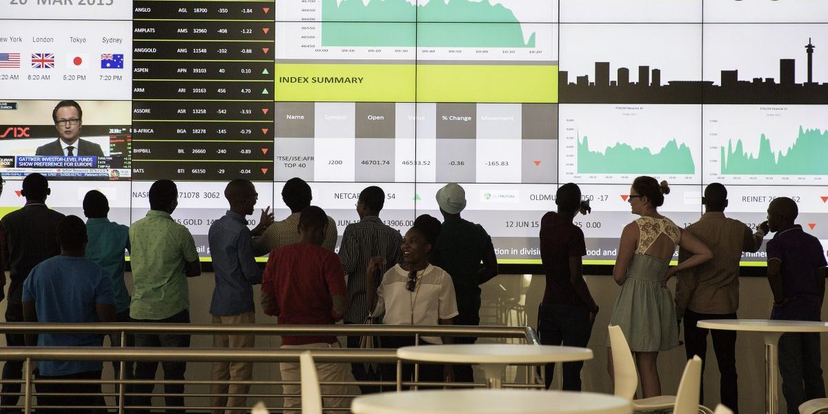 People from a school group look at an electronic screen with stock index figures at the Johannesburg Stock Exchange (JSE) in Johannesburg, South Africa. Image: Getty, Gianluigi Guercia/AFP