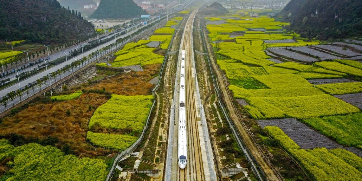 This aerial photo taken on March 16, 2017 shows a high-speed train traveling on the railway in Anshun, southwest China's Guizhou province. Image: Getty, Johnston Earley/AFP