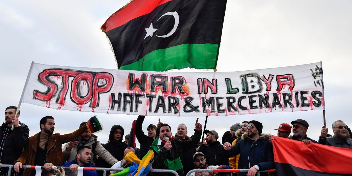 Protesters hold a banner reading "Stop war in Libya, Haftar and mercenaries" during a protest near the chancellery during the Peace summit on Libya at the Chancellery in Berlin on January 19, 2020. Image: Getty, John Macdougall/AFP
