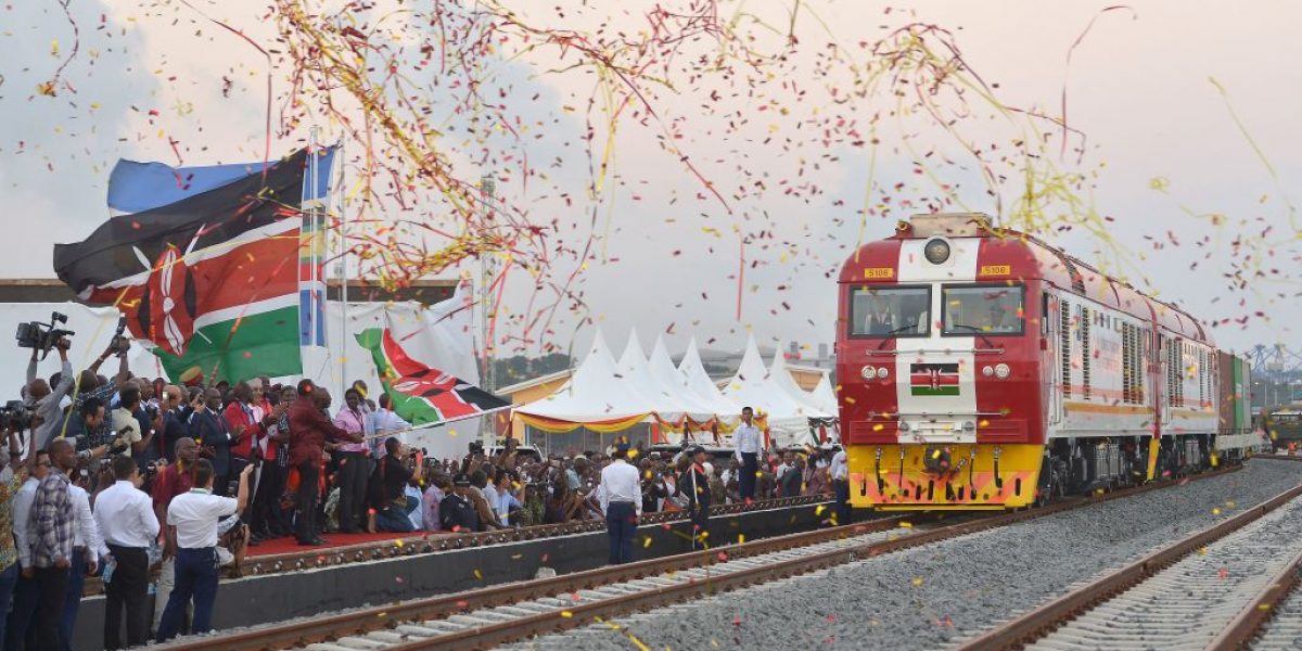 Kenyan President Uhuru Kenyatta flags off a cargo train, as it leaves the container terminal for its inaugural journey to Nairobi, at the port of the coastal town of Mombasa on May 30, 2017. Image: Getty, AFP / Tony Karumba