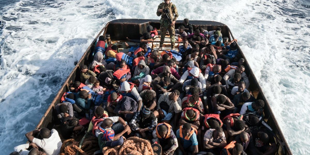 A Libyan coast guardsman stands on a boat during the rescue of 147 illegal immigrants attempting to reach Europe. Image: Taha Jawashi/AFP/Getty Images