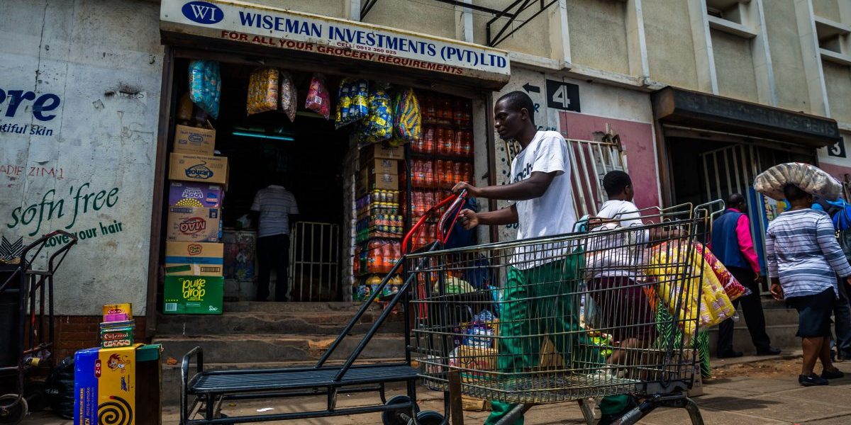 A man pushes a cart through a market as business continues in the Zimbabwean capital, Harare, on
16 November 2017, a day after the military announced plans to arrest ‘criminals’ close to the president.
Zimbabweans faced an uncertain future after the army took power and placed President Mugabe, a
liberation hero turned authoritarian leader, under house arrest. Image: Getty, STR/AFP