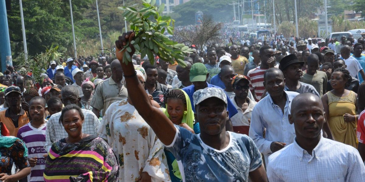 People gather to demonstrate outside the office of the United Nations Human Rights Commissioner in Bujumbura. Image: Getty, Tony Karumba/AFP