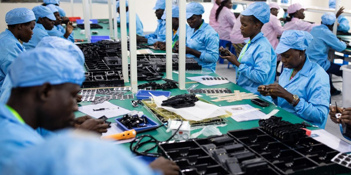 Ugandan factory workers assemble mobile phone cases. Uganda’s first mobile phone electronics factory has been operating in Namanve, near Kampala,	since August 2019. Image: Getty, Luke Dray