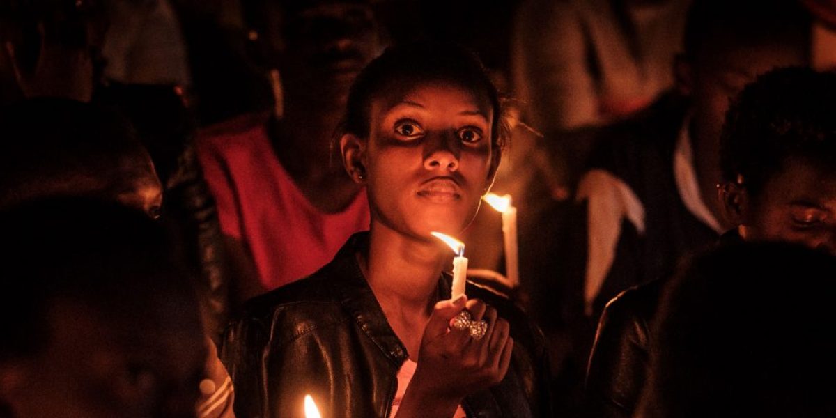 A woman holds a candle during a night vigil and prayer at the Amahoro Stadium as part of the 25th Commemoration of the 1994 Genocide, in Kigali, Rwanda, on 7 April 7, 2019. Image: Getty, Yasuyoshi Chiba / AFP